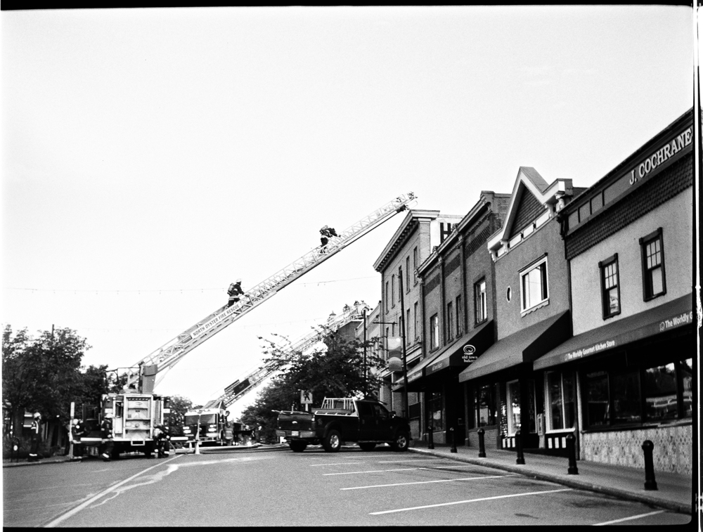Local firefighters engaging in the last ladder practice on the old Island Hotel. The hotel will now house condominiums with several extra stories above the old roofline